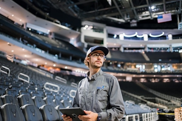 Commercial HVAC technician inspecting rooftop control board